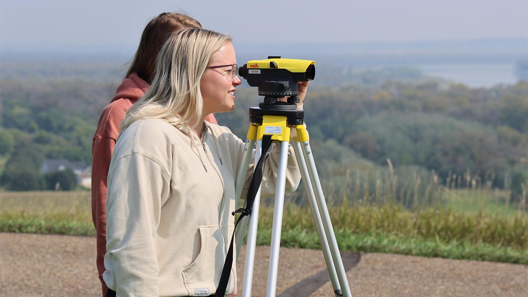 Students doing surveying work outside